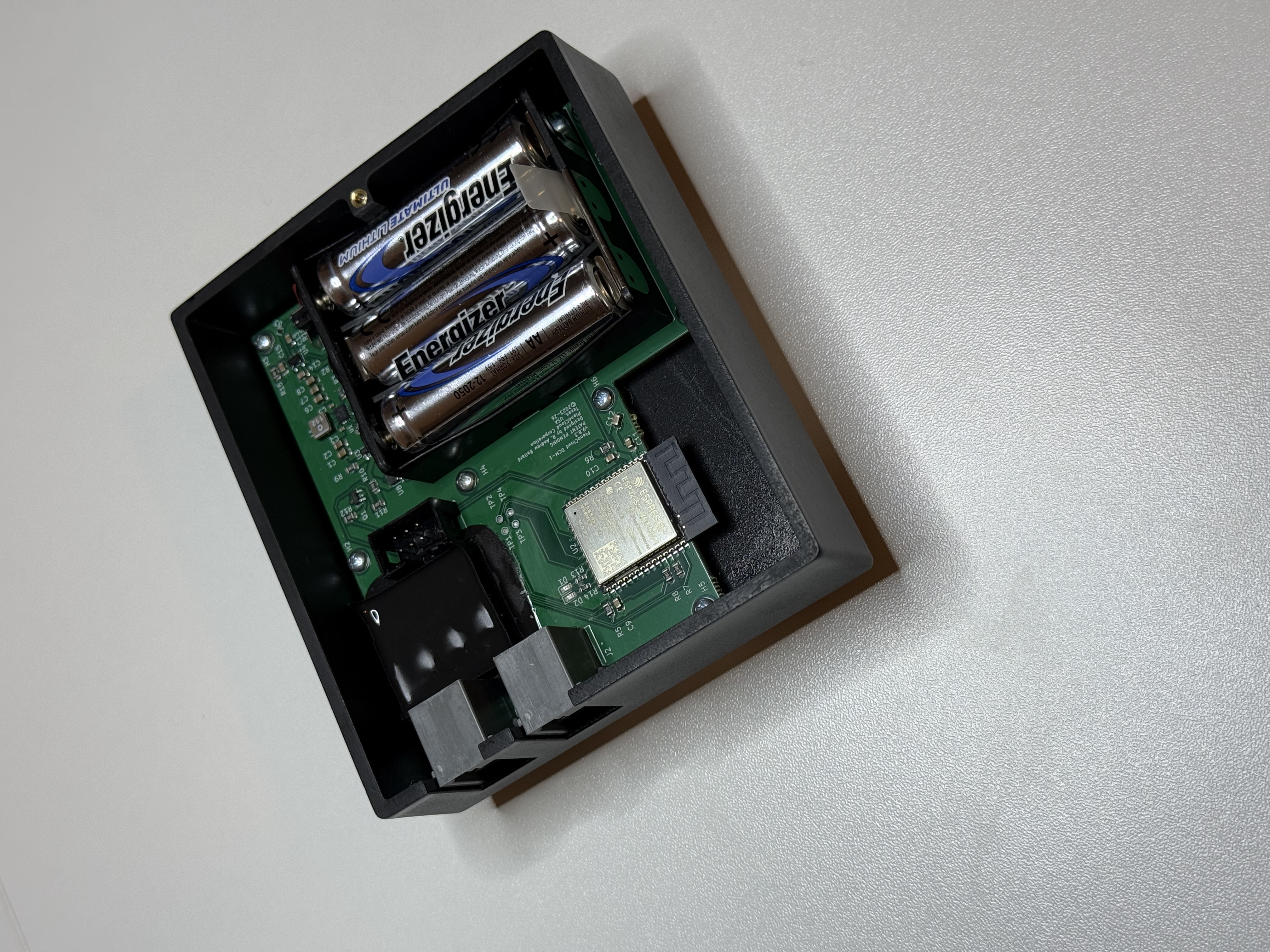 DCM-1 internals showing ESP32 module and battery compartment