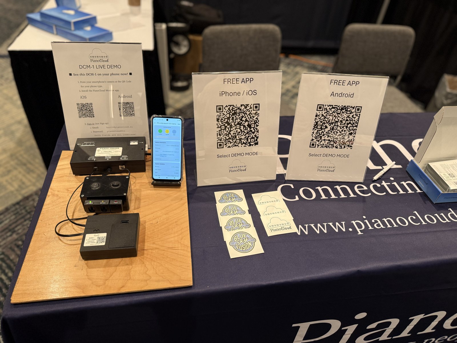 DCM-1 live demo table with app QR placards at PTG 2026